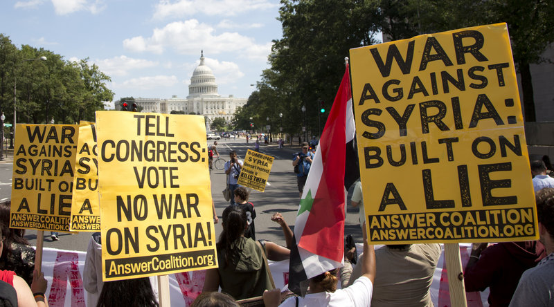 Protesters against U.S. military action in Syria march to Capitol Hill from the White House in Washington on Saturday. President Obama has asked Congress to approve the use of force following a deadly chemical gas attack on Aug. 21.