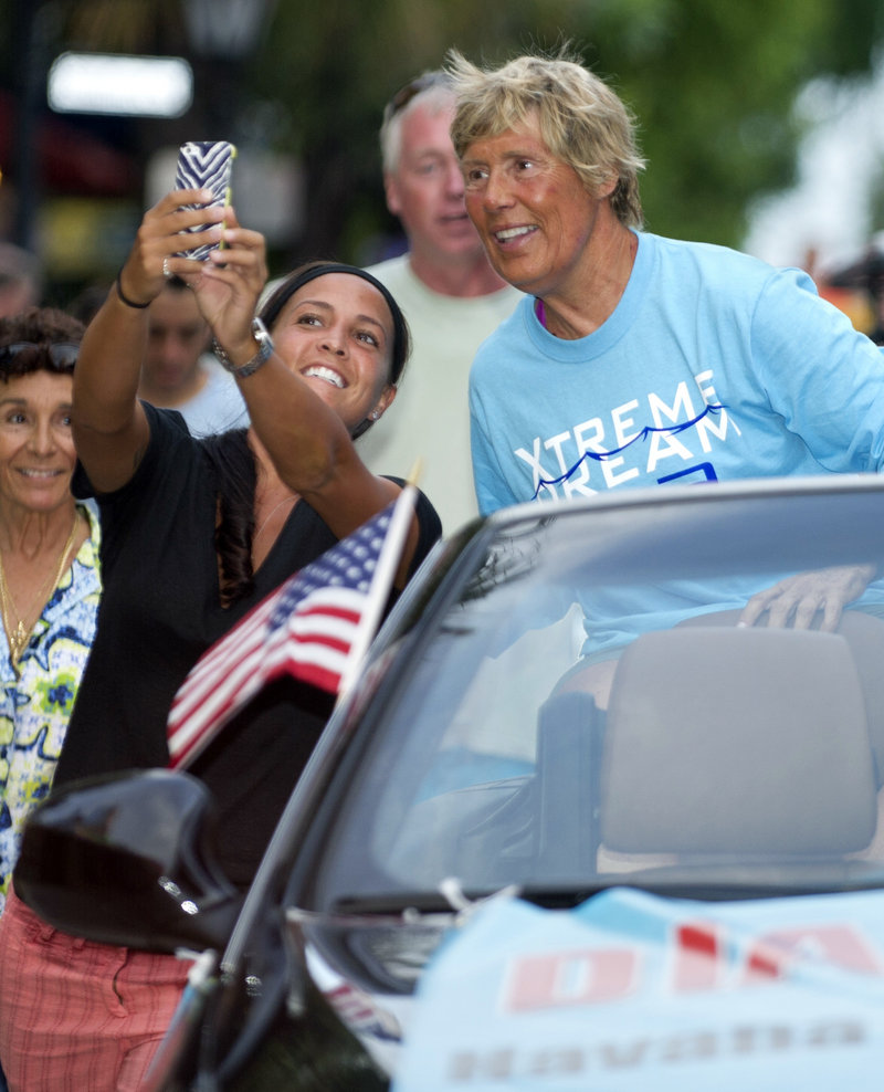 Diana Nyad views a fan’s photo Tuesday during a parade in Key West, Fla.