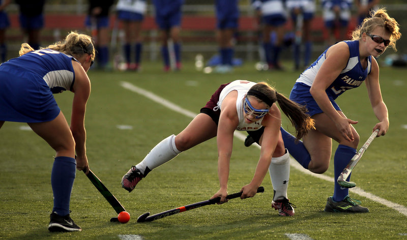 Michaela Pinette of Cape Elizabeth gets caught between Falmouth defenders Jillian Rothweiler, left, and Morgan Allen in Monday night’s game at Cape Elizabeth. Falmouth won to improve to 2-0.