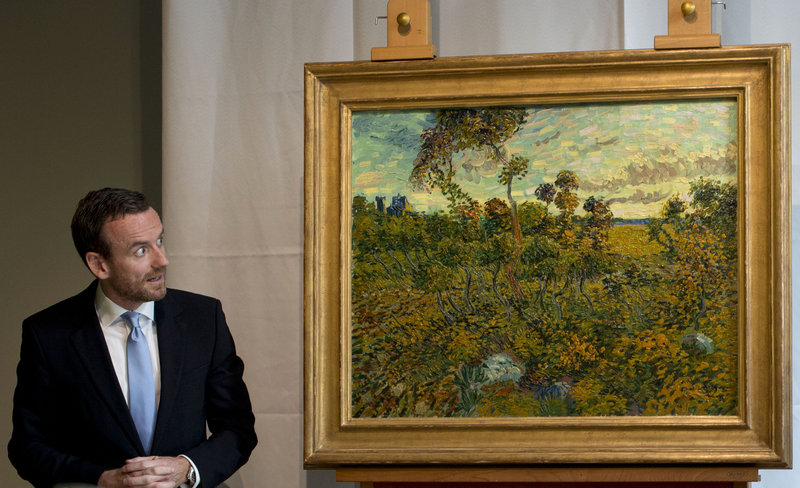 Van Gogh Museum director Axel Rueger looks at “Sunset at Montmajour” after unveiling the painting by Dutch painter Vincent van Gogh during a news conference at the museum in Amsterdam on Monday. It’s the first van Gogh discovery since 1928.