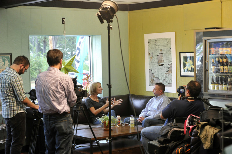 Shannon Moss interviews Police Chief Michael Sauschuck at Holy Donut in Portland for her self-produced local TV show.