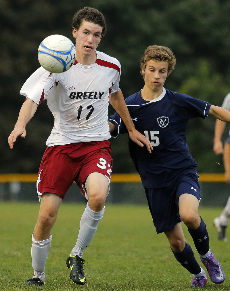 Greely's Samuel Porter keeps his eye on the ball as he tries to advance it up the field against Yarmouth's David Clemmer.