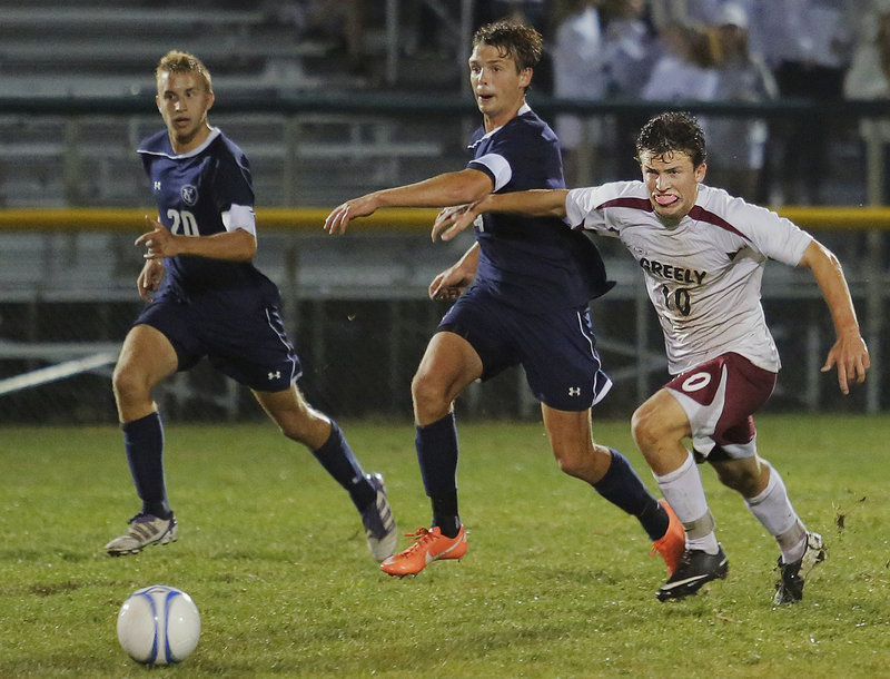Greely's Matthew Crowley (10) tries to hold back Yarmouth's David Murphy (4) and Chandler Smith (20) while going for the ball late in the second half Tuesday.