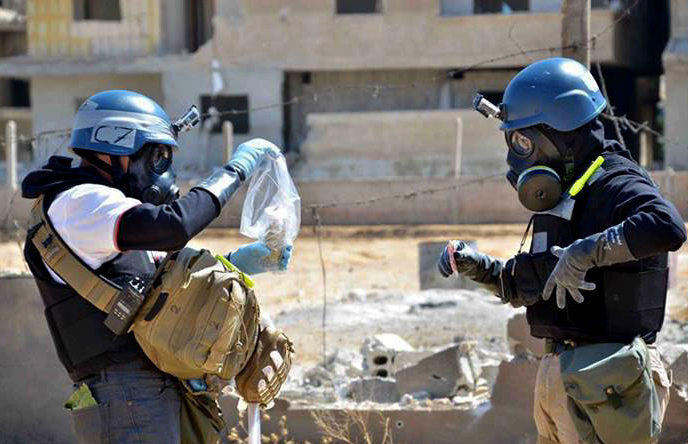 Members of a U.N. team take samples from sand to test for chemical weapons use in Syria. Russia’s proposal to place Syria’s chemical weapons stockpile under international control for dismantling would involve a complicated process.