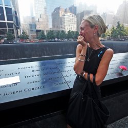 Carrie Bergonia looks over the name of her fiance during ceremonies at the 9/11 Memorial marking the 12th anniversary of the 9/11 attacks on the World Trade Center in New York
