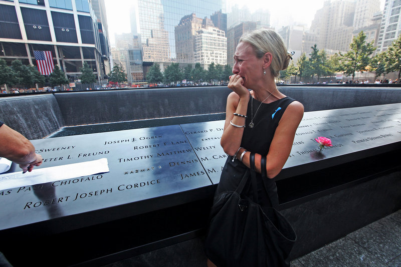 Carrie Bergonia views the name of her fiance, firefighter Joseph Ogren, during ceremonies Wednesday at the 9/11 Memorial marking the 12th anniversary of the attacks on the World Trade Center in New York.
