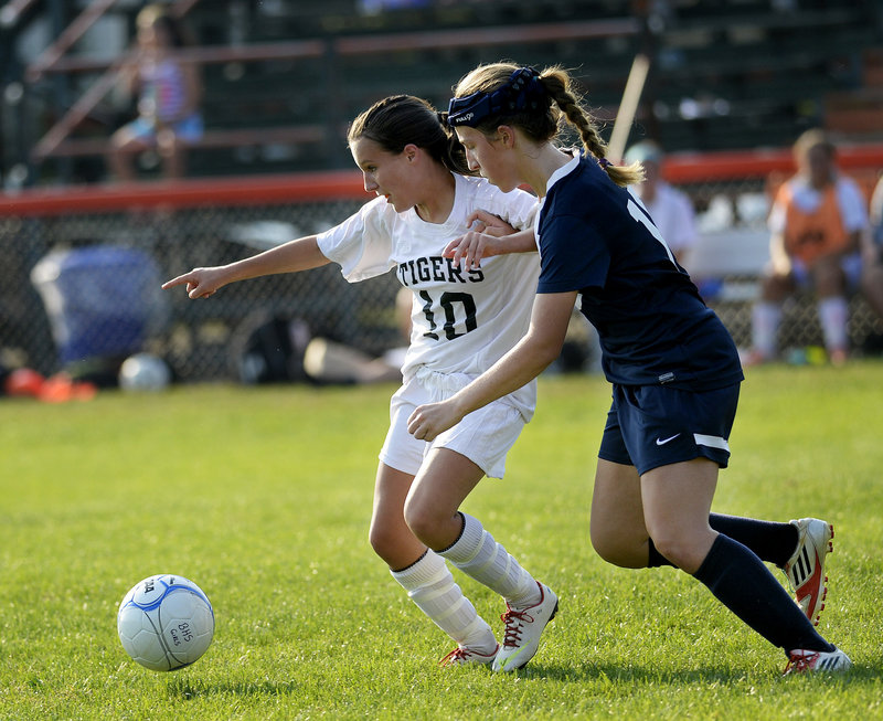 Olivia Paquette, left, who scored the winning goal for Biddeford, competes with Alexa Lynham of Westbrook for the ball Wednesday during Biddeford’s 3-2 victory.