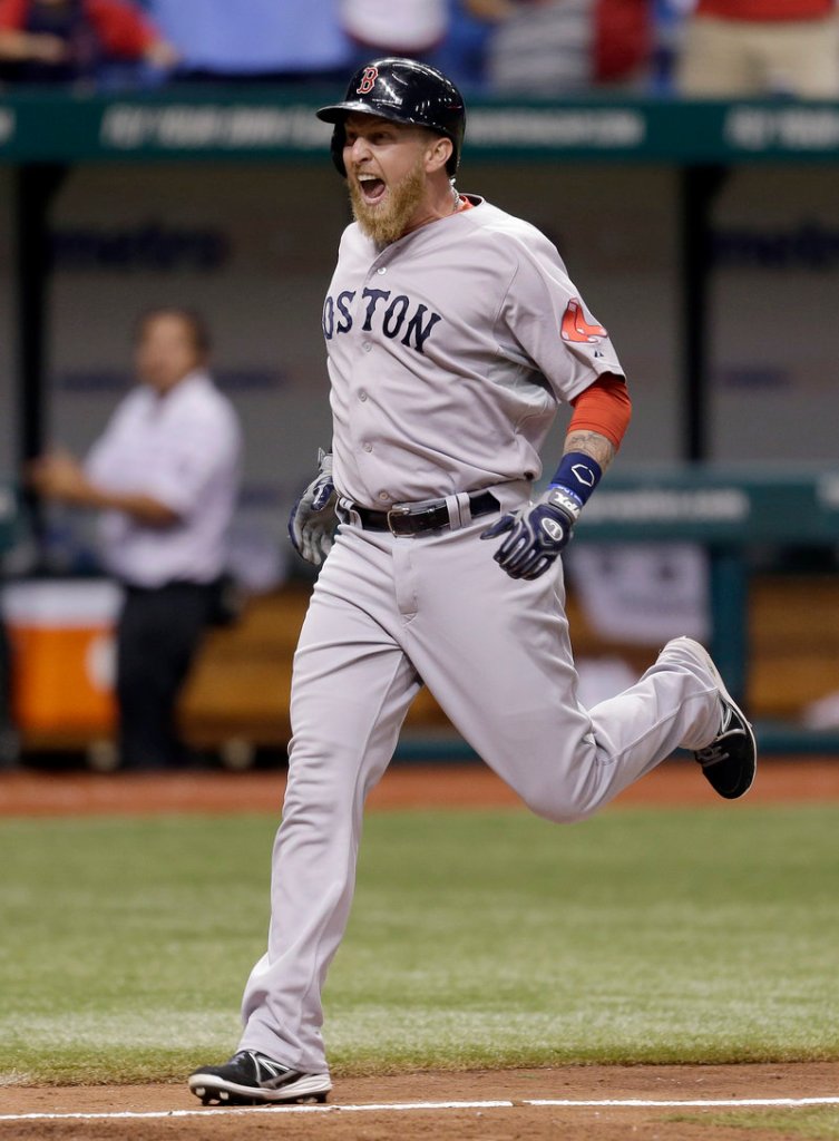 Mike Carp reacts Wednesday night as he heads for the plate after his 10th-inning grand slam helped lift the Red Sox over the Rays, 7-3.