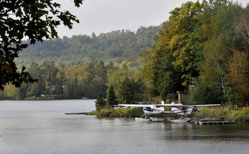 Seaplanes rest on Lower Shin Pond in Mount Chase, where the local economy depends on snowmobiling and hunting.