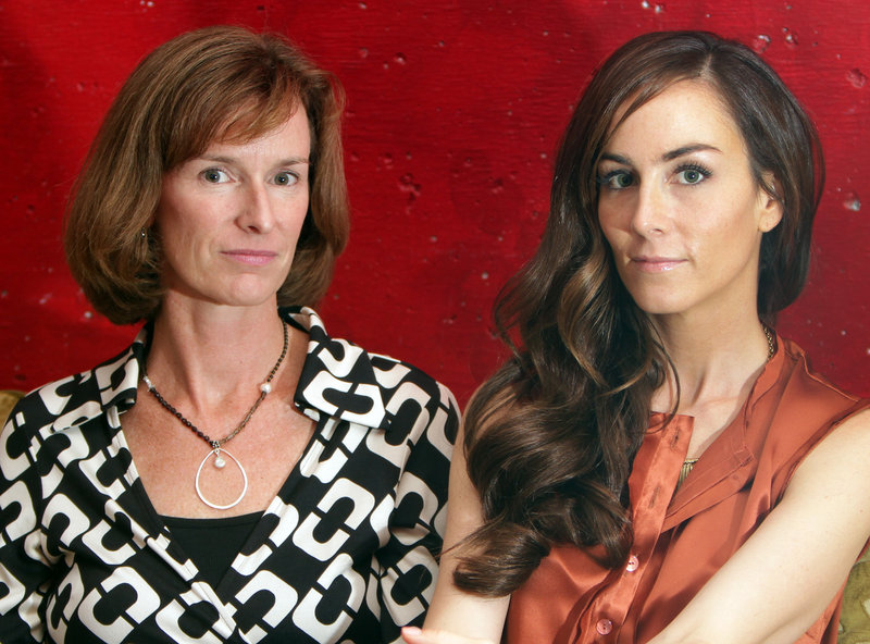 Canadian journalist Amanda Lindhout, right, and Portland writer Sara Corbett, co-authors of “A House in the Sky,” pose Thursday for a photo at Brookline Booksmith in Brookline, Mass., during their book tour. “A House in the Sky” is a memoir that describes Lindhout’s life in captivity in Somalia.