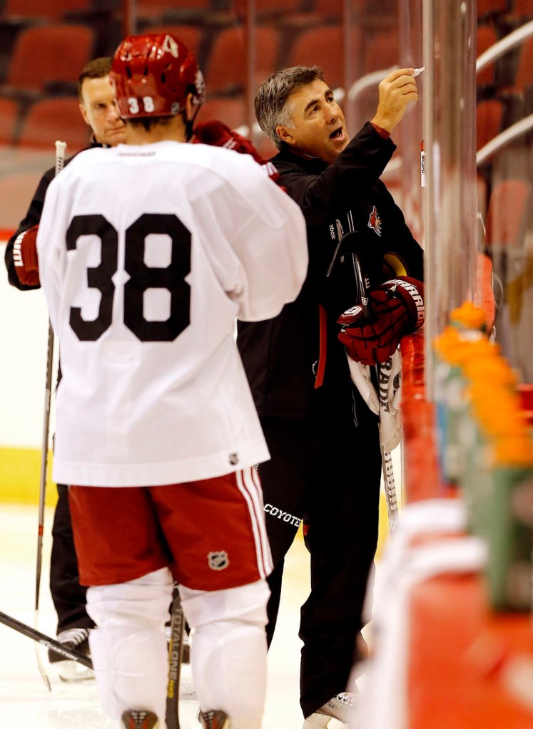Phoenix Coach Dave Tippett diagrams a play during the Coyotes’ first day of training camp in Glendale, Ariz. The Coyotes look to rebound after a disappointing season.