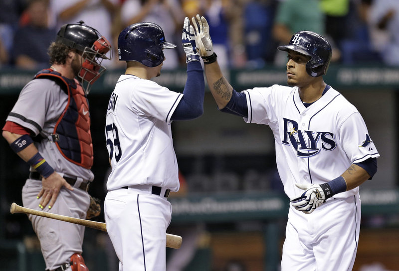 Desmond Jennings, right, receives a welcome-home from Jose Lobaton after hitting a home run in the third inning Thursday night for Tampa Bay in a 4-3 win over Boston. The catcher is Jarrod Saltalamacchia.