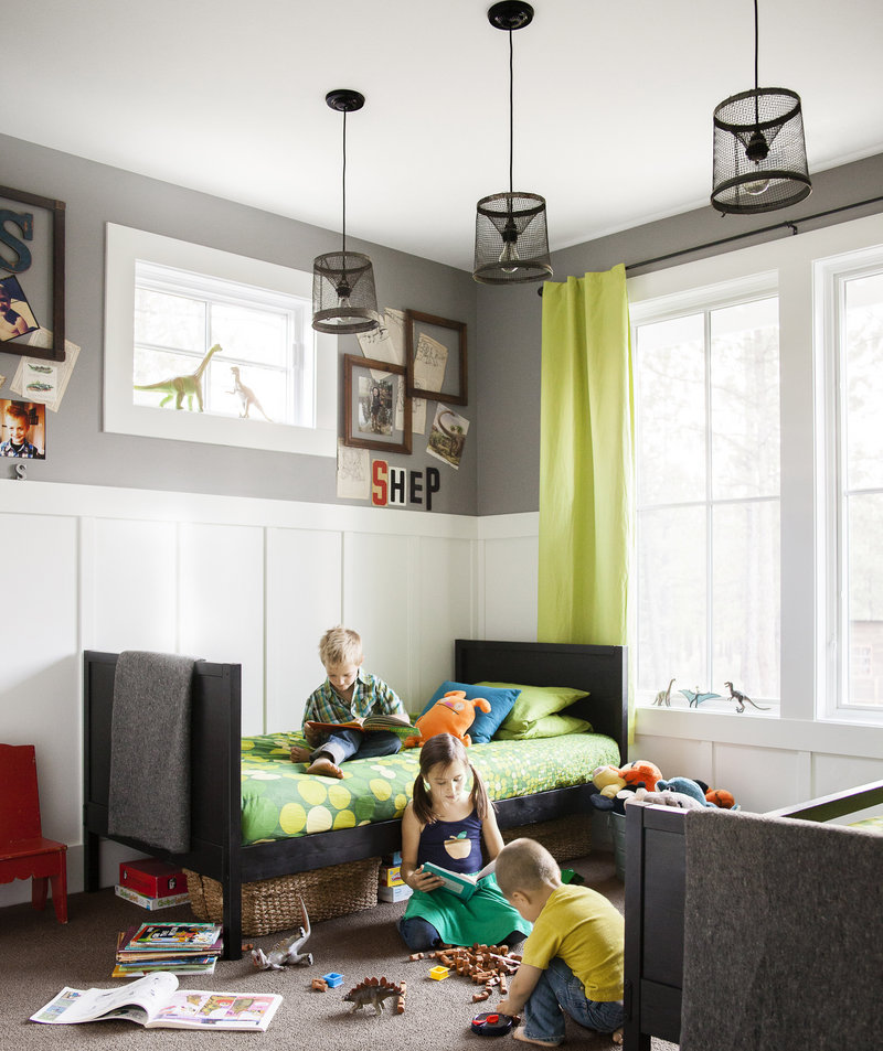 Grown-up light fixtures, a colorful window panel and empty frames for pin-ups all make this children’s bedroom featured in Country Living feel sophisticated.