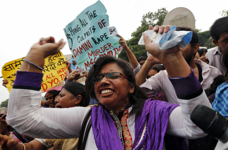 A protester shouts Friday outside a court in New Delhi, India. All four men convicted of raping and murdering a 23-year-old woman in New Delhi were sentenced to death.