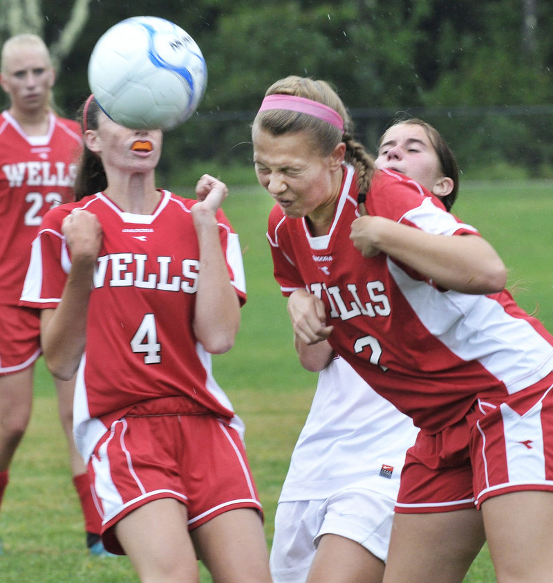 Maddie Taylor of Wells heads the ball in front of teammate Natalie Thurber. The Warriors’ comeback bid fell short in a 2-1 loss to Freeport.