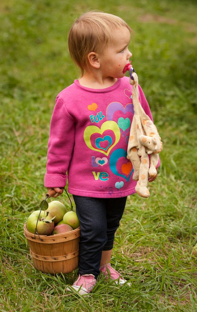 Kami Leroux, 2, of Peaks Island totes her own basket – and a friend.