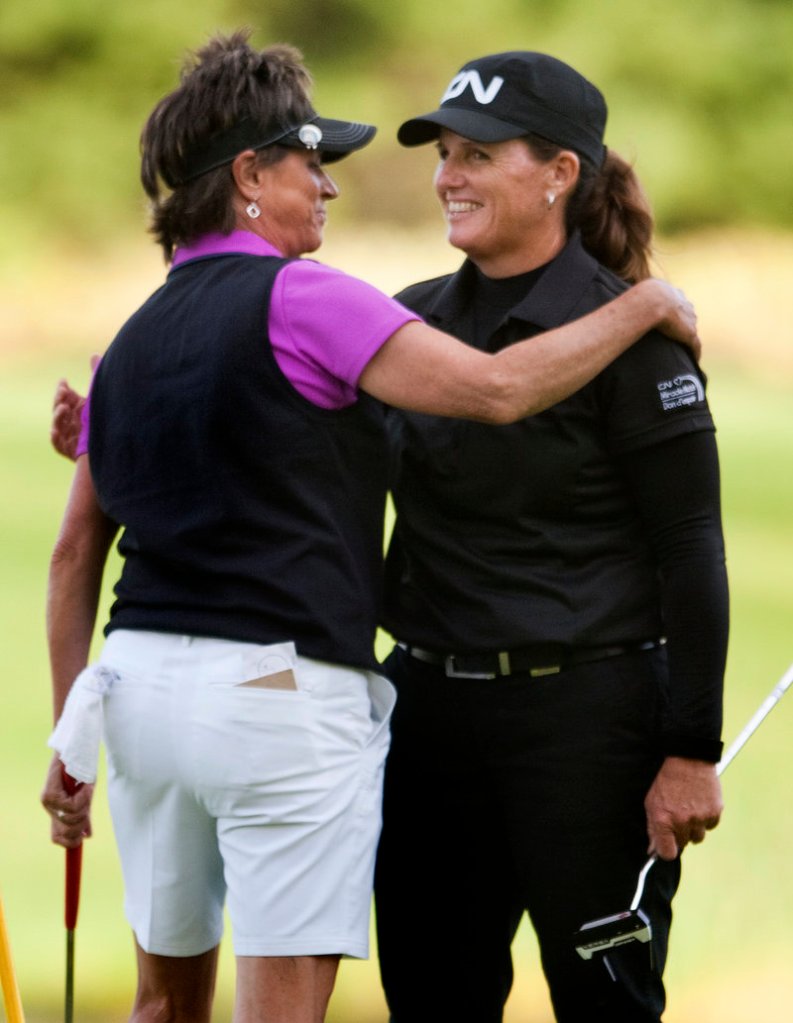 Rosie Jones, left, hugs challenger Lorie Kane after winning a five-hole playoff Sunday to capture the Harris Golf Charity Classic at Falmouth Country Club.