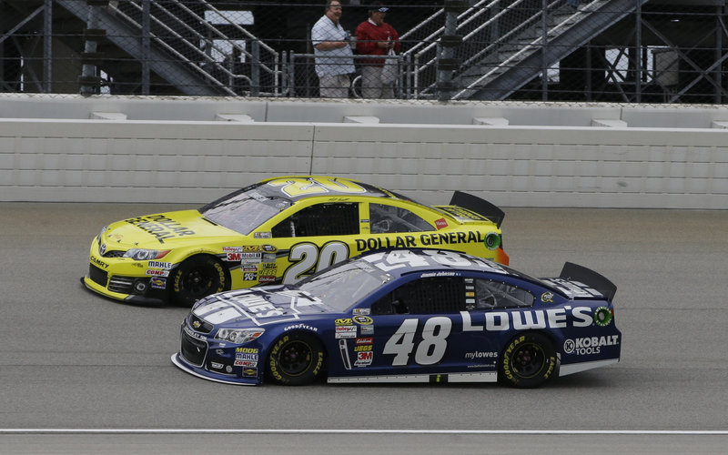 Matt Kenseth (20) drives past Jimmie Johnson during the NASCAR Sprint Cup auto race Sunday en route to victory at Chicagoland Speedway. Johnson finished fifth.