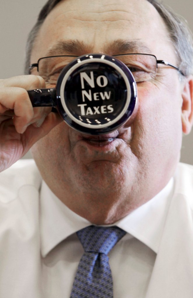 Gov. LePage takes a sip out of a coffee mug displaying a “no new taxes” message in a 2012 file photo. By declining to accept Affordable Care Act funds to expand MaineCare eligilbility, the governor and his Republican allies in the Legislature saved Maine taxpayers money, a reader says.