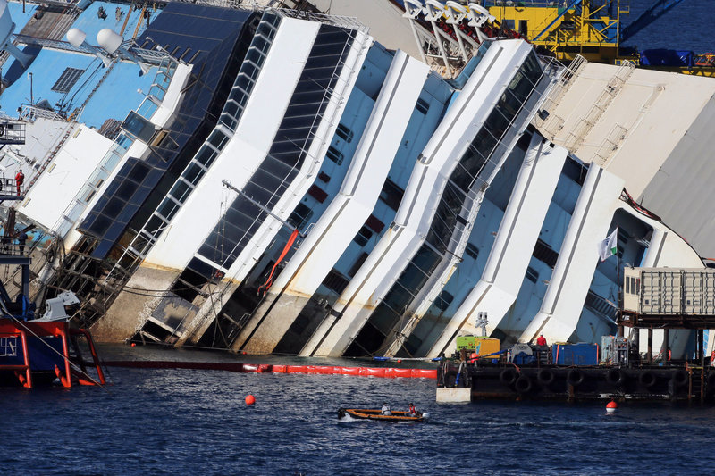 The Costa Concordia lies on its side near Giglio, Italy, as engineers work to raise it off a reef .