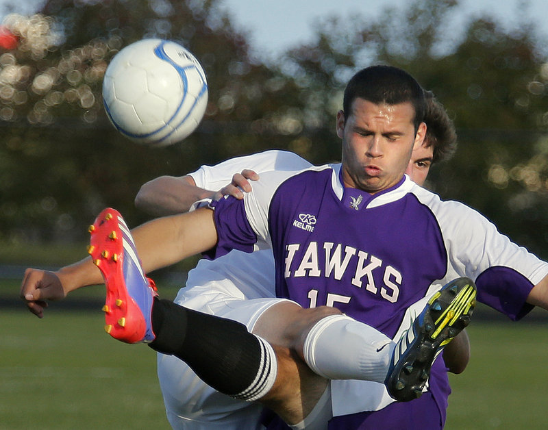 Noah McDaniel, front, of Marshwood and Colin Grove of Cheverus get tangled up as they battle for the ball during an SMAA soccer match Monday in Portland. Grove led the Stags to a 5-1 triumph.