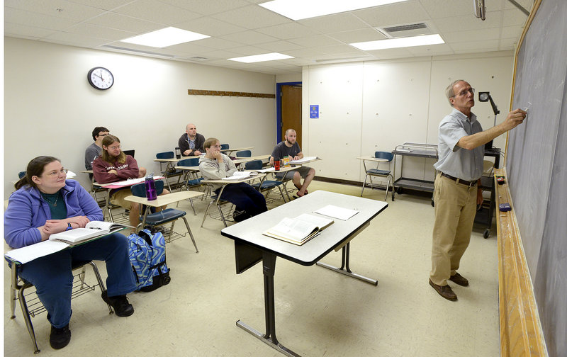 Bob Coakley teaches a physics class at the University of Southern Maine campus in Portland last week. The move to cut physics has rankled faculty, students and members of the community, who have written letters in support of keeping the program.
