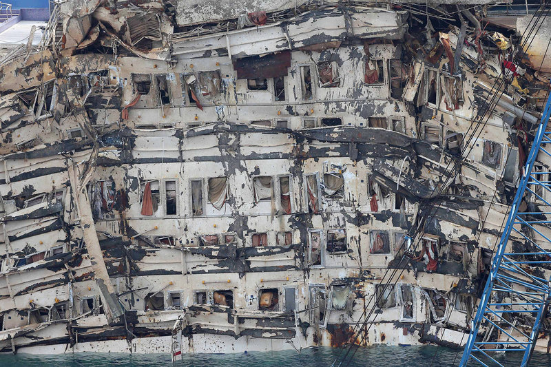 The deformed side of the Costa Concordia is seen after it was lifted upright off the island of Giglio, Italy, Tuesday. The crippled ship was pulled completely upright by counterweights.