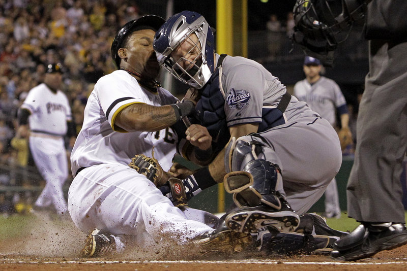 Pittsburgh’s Marlon Byrd is tagged out by San Diego catcher Nick Hundley in the third inning of the Pirates’ 5-2 loss at Pittsburgh on Tuesday night.