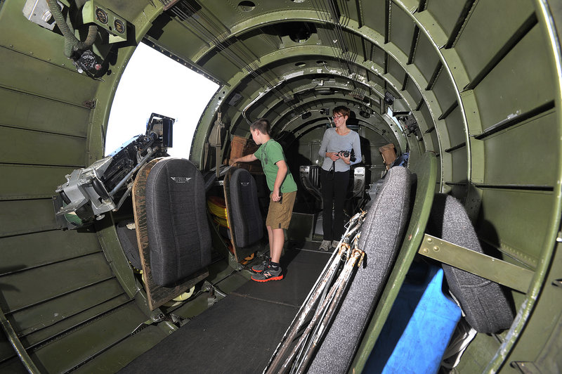 Nathan Giddinge, 10, of Pownal, checks out the interior of the B-17 bomber with his mother, Erica. She said her son recently brought home a library book about World War II aircraft and has been talking to his grandfather about the war.