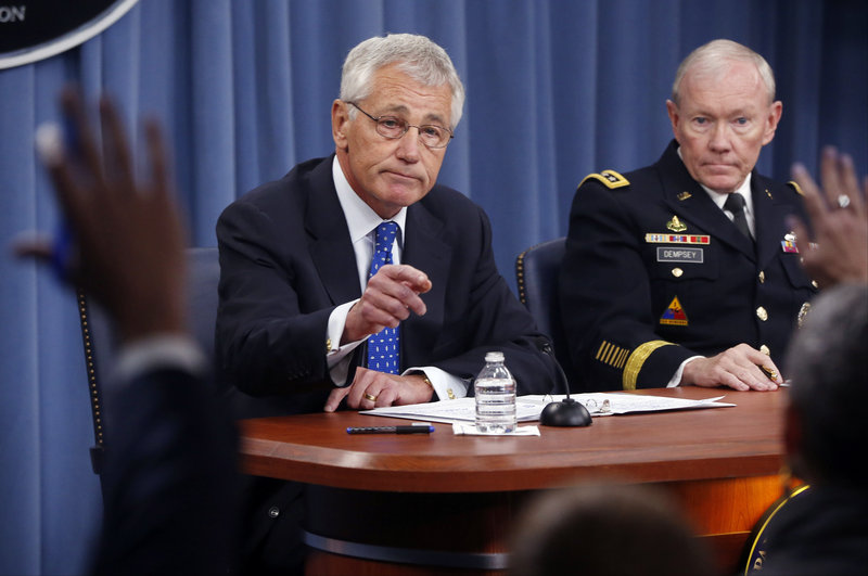 Defense Secretary Chuck Hagel and Chairman of the Joint Chiefs of Staff Gen. Martin Dempsey take questions at The Pentagon Wednesday after Hagel said he is ordering a review of the physical security of all U.S. defense facilities worldwide.