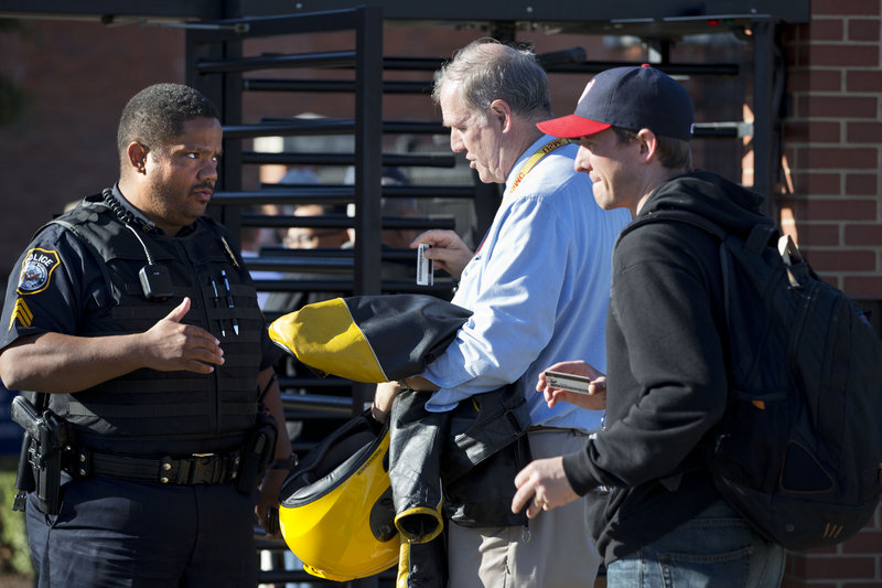 A police officer answers questions as employees ready their identification at the Navy Yard in Washington on Wednesday.