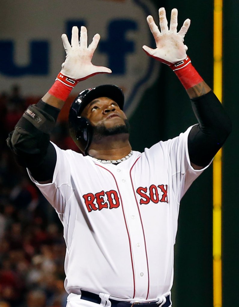 Boston’s David Ortiz raises his hands as he crosses the plate after hitting a two-run homer in the first inning of what turned out to be a 5-3, 12-inning loss to the Orioles at Fenway Park.