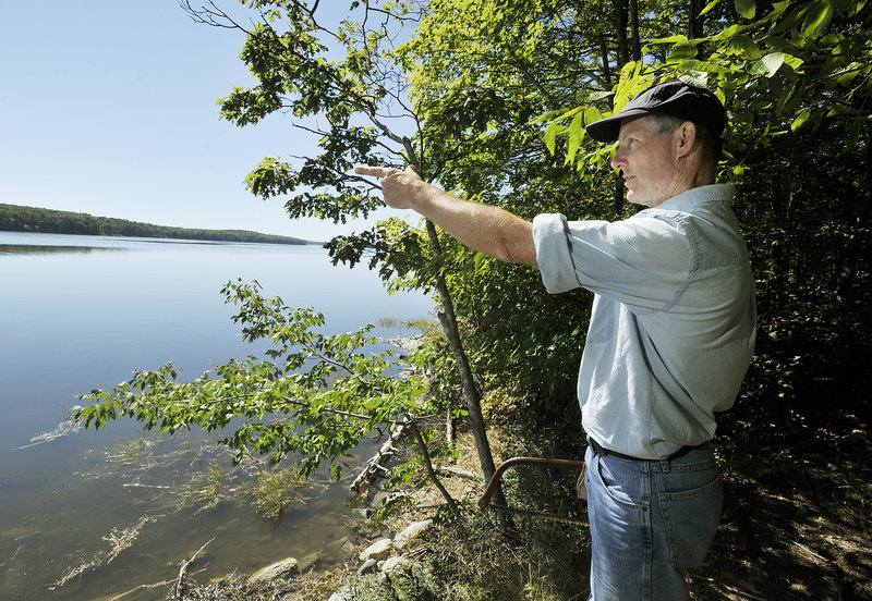 Henry Heyburn points to Westport Island as he leads a hike on the Eaton Farm Trail.