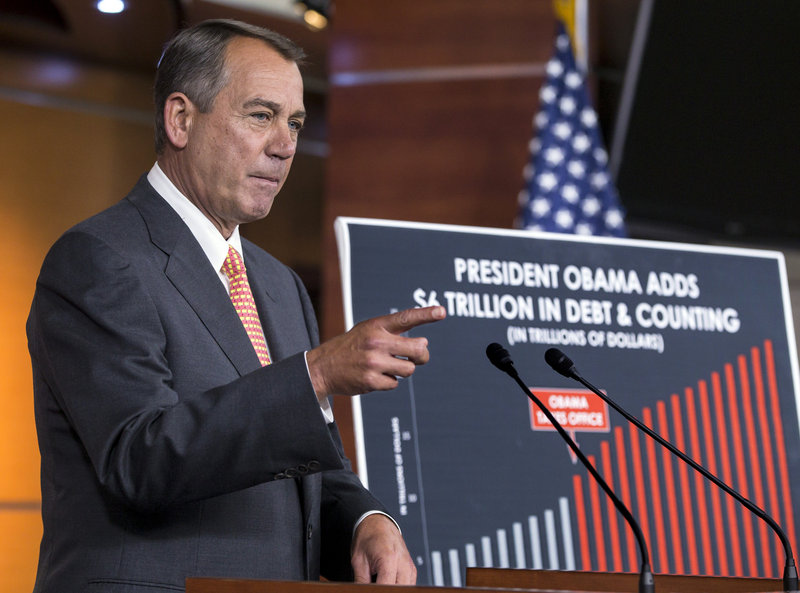Speaker of the House John Boehner, R-Ohio, talks to reporters in Washington on Thursday about the fight over the budget on Capitol Hill as critical deadlines to fund the government loom.