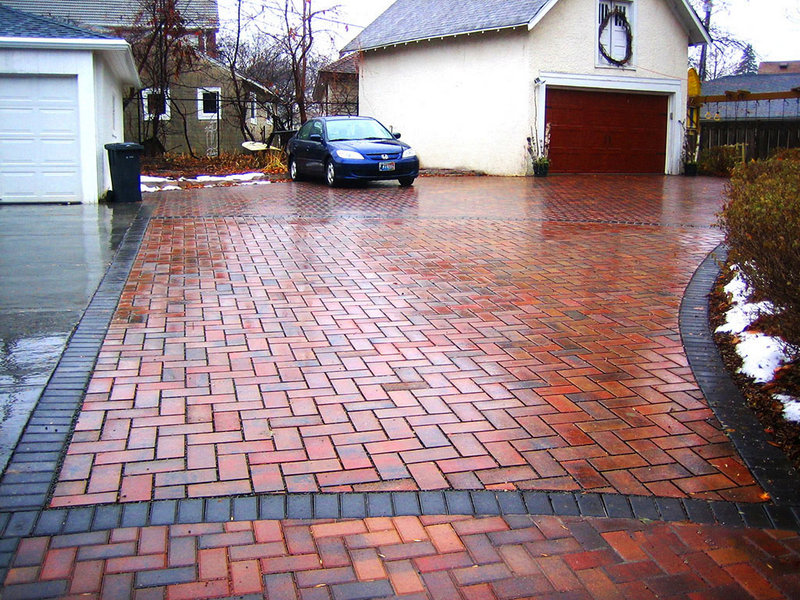 Permeable pavers in a Minnesota driveway let water absorb back into the ground rather than running off and carrying pollution to the nearest water.