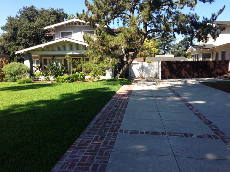 Reclaimed bricks from the 1920s accent a new concrete drive with an antique finish in Pasadena, Calif.