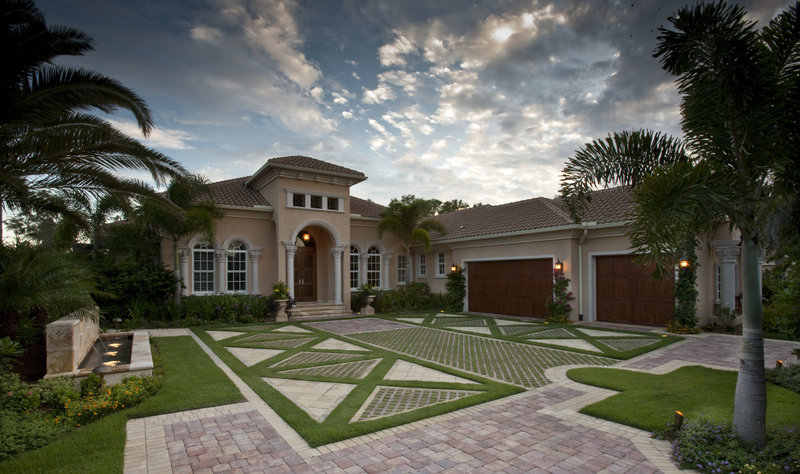 In a living driveway in Naples, Fla., grass is interspersed among pavers, which reduces heat and glare and provides drainage. It was designed by landscape architect W. Christian Busk.