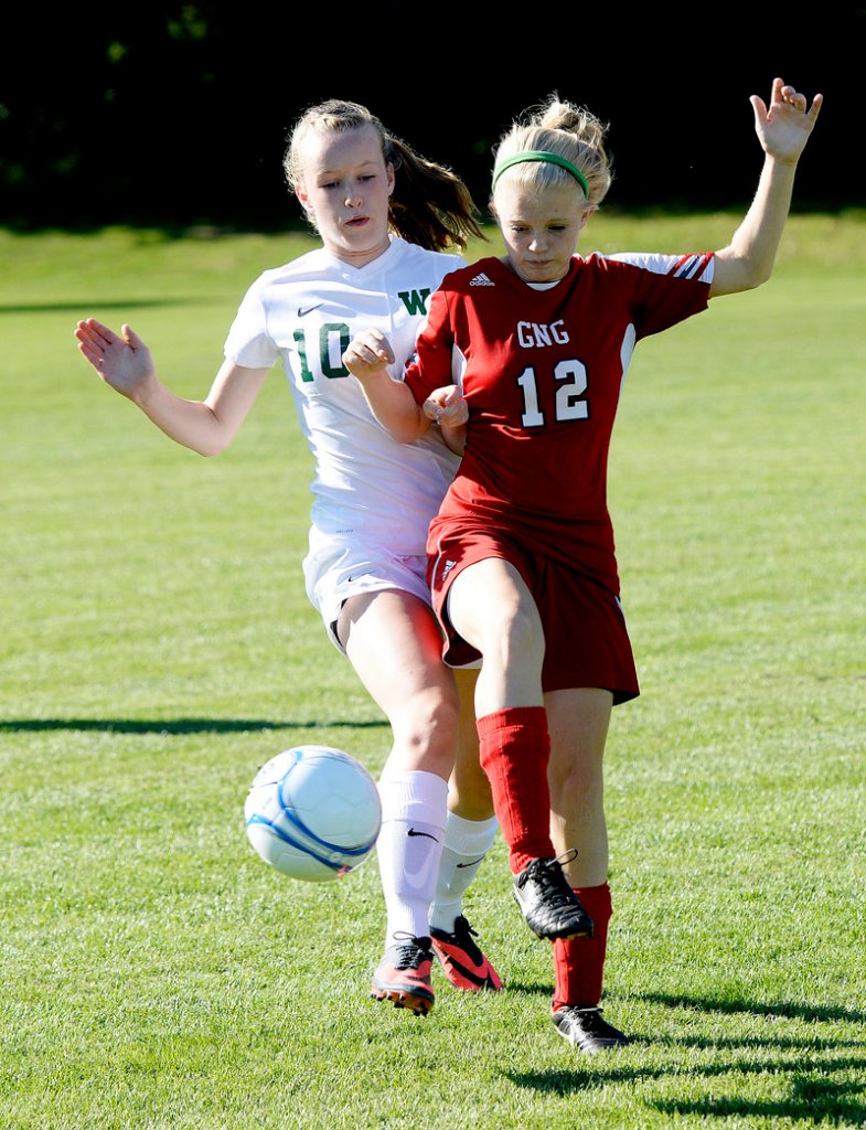Arianna Giguere, left, of Waynflete fights for possession with Emily Hotham of Gray-New Gloucester.