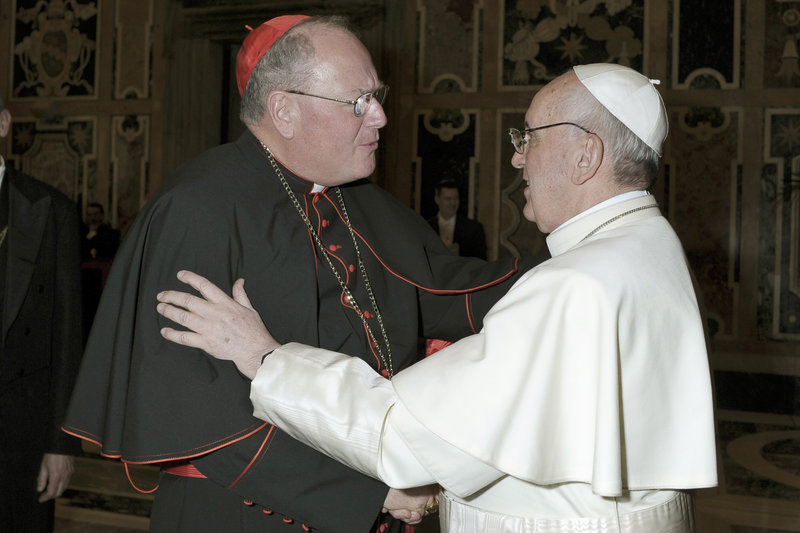 Pope Francis is greeted by Cardinal Timothy Dolan, archbishop of New York, on March 15 as he meets the cardinals for the first time after his election at the Vatican.