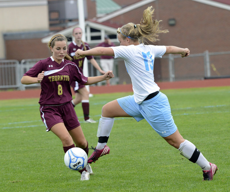 Cassie Symonds of Windham pushes the ball past Thornton Academy’s Megan Hurrell during their SMAA girls’ soccer match Saturday. Windham improved to 5-0 with a 1-0 triumph.