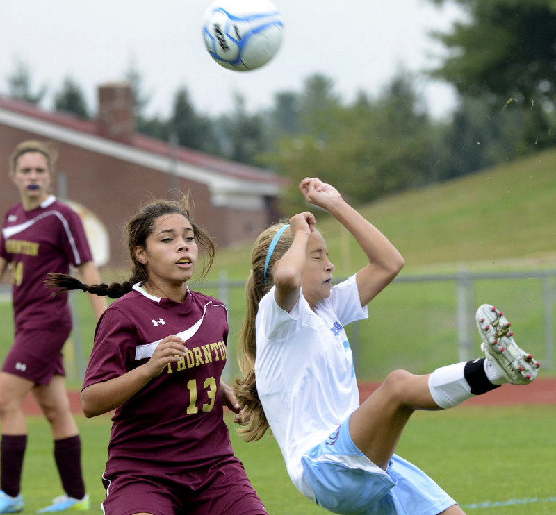 Holly Spencer, right, of Windham reacts after deflecting the ball past Thornton Academy’s Allie Pettaway.