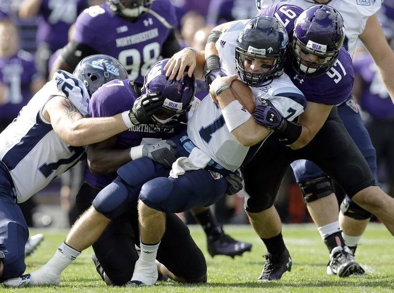 UMaine quarterback Marcus Wasilewski was hit hard in the first quarter of Saturday’s 35-21 loss to Northwestern, yet finished the day throwing for 237 yards, two touchdowns and two interceptions against the No. 18-ranked team in the country.