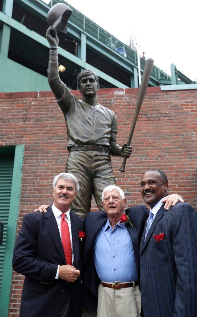 Accompanied by former teammates Dwight Evans, left, and Jim Rice, right, Carl Yastrzemski stands by the new statue outside Fenway Park.