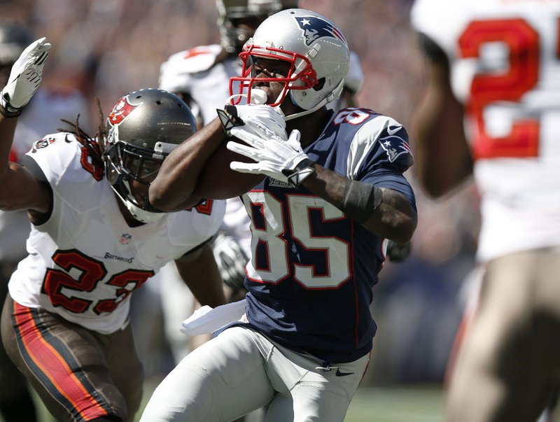 New England Patriots wide receiver Kenbrell Thompkins runs past Tampa Bay Buccaneers strong safety Mark Barron for a touchdown after catching a Tom Brady pass Sunday.