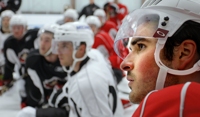 Mathieu Brodeur listens attentively as Coach Ray Edwards describes a drill during the Portland Pirates’ first day of training camp at the MHG Ice Centre in Saco. Brodeur, a third-round Phoenix Coyotes’ draft pick in 2008, is about to start his third season as a Pirate.