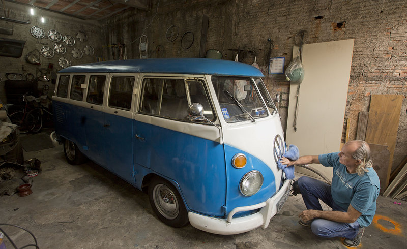 Enio Guarnieri wipes the VW emblem of his 1972 Volkswagen van in Sao Paulo, Brazil. Guarnieri bought the vehicle a year ago for sentimental reasons: When he was 10 years old, his father taught him to drive a Volkswagen bus.