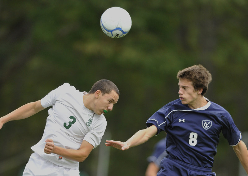 Harry Baker-Connick of Waynflete, left, heads the ball past Walter Conrad of Yarmouth during Yarmouth’s 3-0 victory Tuesday at the Fore River Complex.