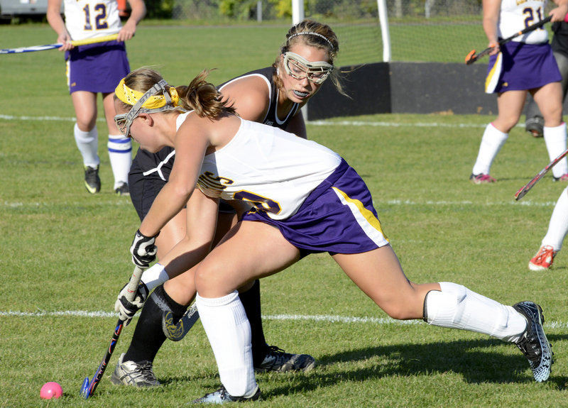 Abby Ford of Cheverus attempts to push the ball away from Karissa Boesch of Marshwood. Colleen Slattery of Cheverus scored the goal.