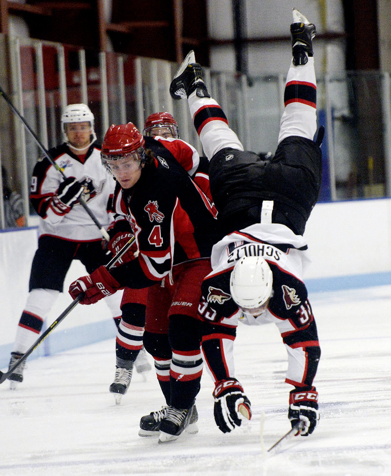 Ian Schultz of the Pirates takes a spill after being tripped by Jordan Murray of the University of New Brunswick in Wednesday’s exhibition game in Saco. The Pirates won, 4-0.
