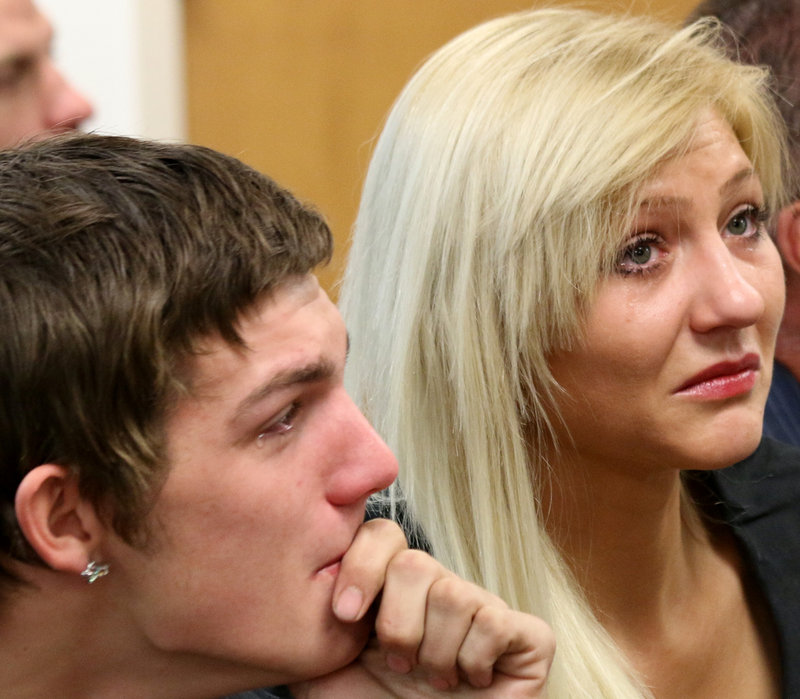 Scott Martin, Darriean Hess' fiancé, left, and Cassandra Clifton, Hess' sister, watch a video screen as Darriean Hess, is arraigned via video in Seabrook, N.H. Wednesday, Sept. 25, 2013. Darriean Hess is charged with two counts of negligent homicide and two counts of assault after she plowed into a group of cyclists on Saturday on a bridge during an annual ride in Hampton. Two riders died and two were injured.